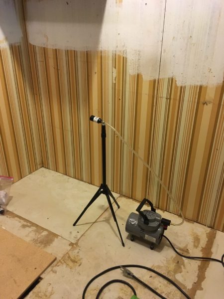 Before: visible vermiculite in a building area that must be treated